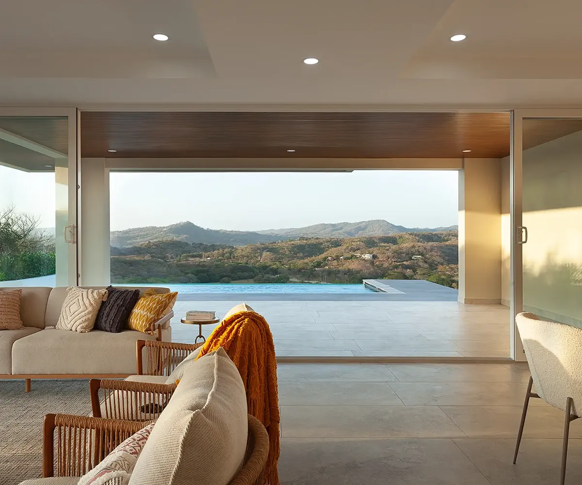 a living room with a pool and a couch, malibu san juan del sur