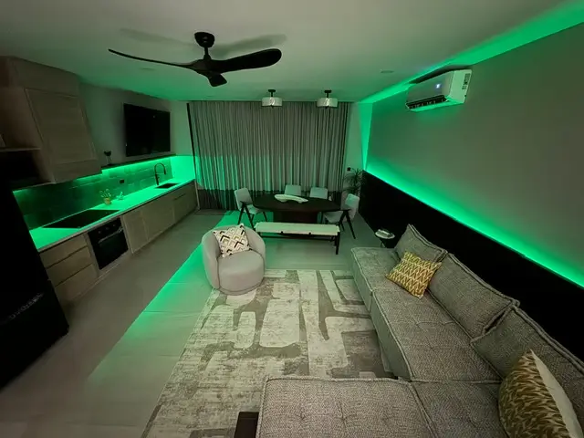 a living room with green lights, malibu nicaragua