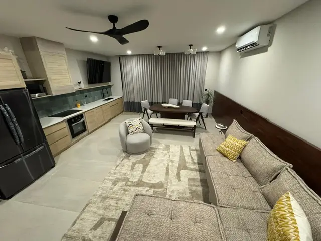 a living room with a couch and a table, malibu san juan del sur